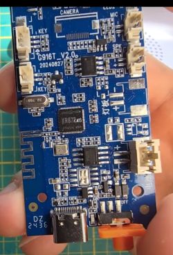 Blue G916T V2.0 PCB with XR872A0 microcontroller held in a hand.