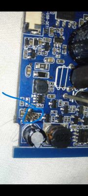 Close-up of a circuit board with a damaged transistor marked in a blue circle.