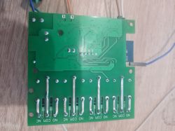 Printed circuit board seen from below, showing traces and solder points.