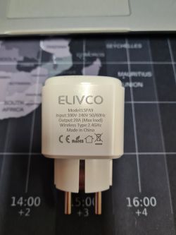 View of an ELIVCO LSPA9 smart plug lying on a world map.