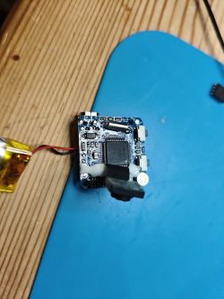 Dismantled SQ11 Mini DV Camera Dismantled mini camera with visible circuit board and components.
