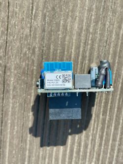 PCB with CB2S module and CE markings on a wooden surface.