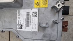 Wbudowana ładowarka samochodu elektrycznego z widocznymi naklejkami informacyjnymi.