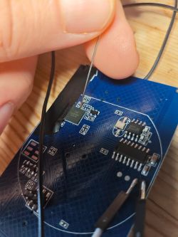 Image of a PCB with a microcontroller and soldered wires.