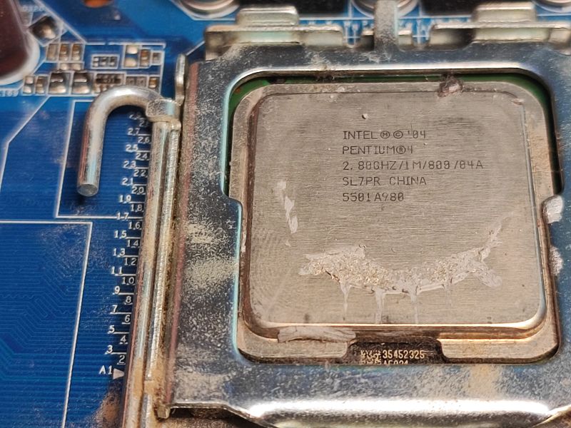 Intel Pentium 4 Processor on Motherboard Close-up of an Intel Pentium 4 processor on an old motherboard.