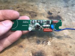 Electronic PIR motion sensor board held in a hand