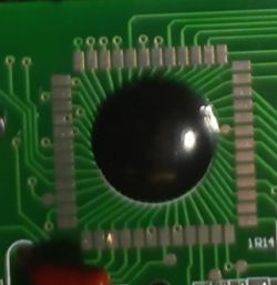 Printed circuit board with an integrated circuit and metal pins.