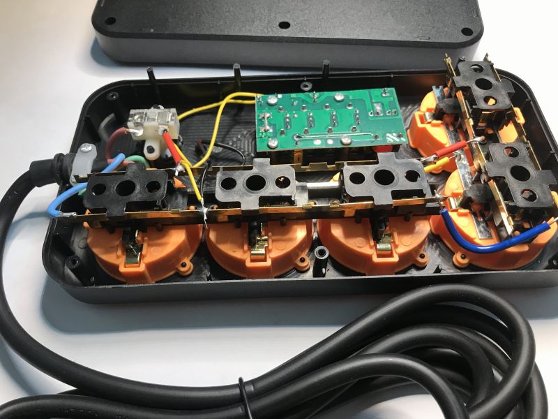 Power strip interior with five AC sockets and visible electrical wiring