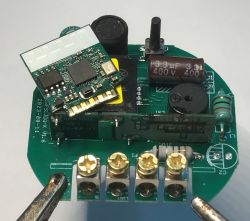 Close-up of a PCB with electronic components and screw terminal connectors