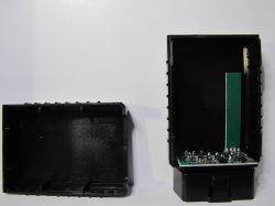 Disassembled OBDII scanner casing with visible PCB.