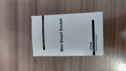 White box labeled “Mini Smart Socket” on a wooden surface