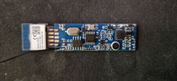 PCB Module with Electronic Components PCB module with electronic components on a black surface.
