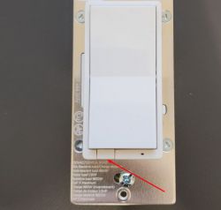 Photo of a smart wall switch with a highlighted button.