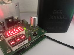 NXT Gear BY-K9 30000 mAh power bank next to a tester showing 18.66 on its display