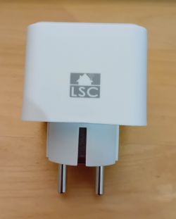 Action LSC Smart Plug White Action LSC smart plug on a wooden surface.