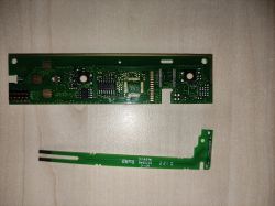 Circuit board with electrical components on a light background.