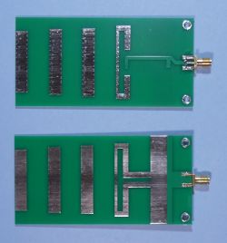 Two green PCB YAGI antennas on a white background.