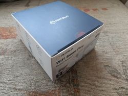 ANTELA WiFi Smart Plug Box ANTELA WiFi Smart Plug box resting on a carpet.