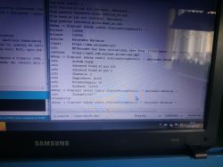 Screen capture of debugging logs on a Samsung laptop monitor.