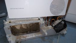 Dirty dryer heat exchanger and fan; “SelfCleaning Condenser” text on the panel