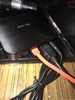 Smart TV Android Box z podłączonymi kablami HDMI i USB na drewnianym biurku.
