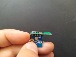 Electronic Module with Pin Labels Person holding an electronic module with pin labels.