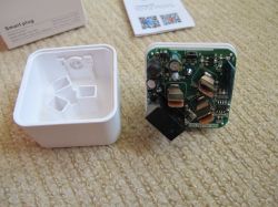 Disassembled Smart Home Plug Disassembled smart home plug on carpet.