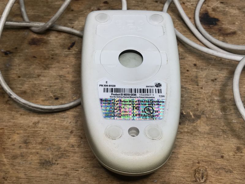 Trekker Two Button Mouse - Bottom View Old Trekker computer mouse with a visible label on its bottom.