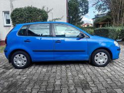 Blue Volkswagen car parked on a paved surface.