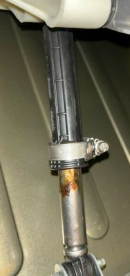 Washing machine damper with corrosion and a hose clamp on the rod