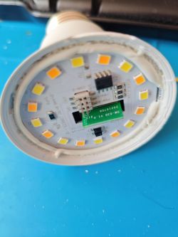 Close-up of a disassembled LED bulb with visible diodes and electronic circuitry.