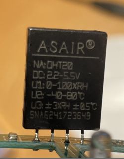 Close-up of an ASAIR DHT20 sensor on an electronic board.