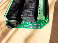 Close-up of an 8-channel Tuya smart switch with visible relays and connectors.
