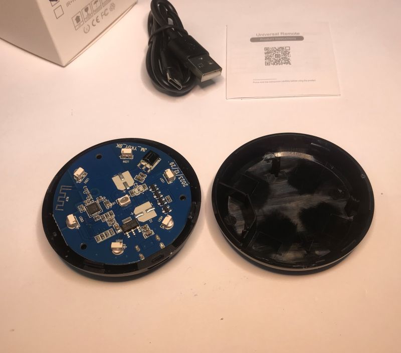 Disassembled Tuya IR universal remote with visible PCB and casing