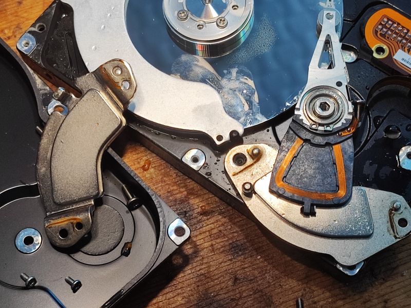 Water-Damaged Hard Drive with Visible Mechanical Components Interior of a water-damaged hard drive showing mechanical components.