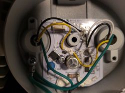 Close-up of an internal module with wires inside an LED floodlight.