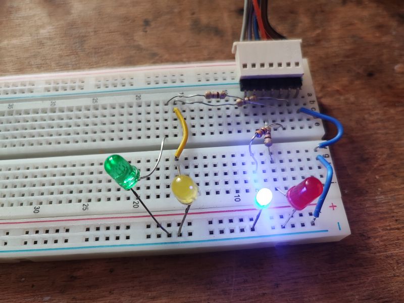 Breadboard with LEDs and Resistors Close-up of a breadboard with colored LEDs and resistors.