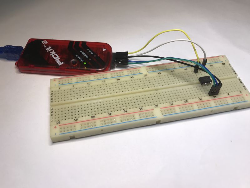 Breadboard with connected PICKIT2 programmer and DIP8 microcontroller