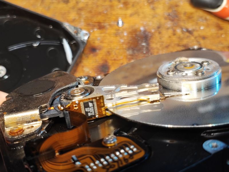 Inside View of an Open Hard Drive Close-up of a hard drive interior with visible platter and read/write arm.