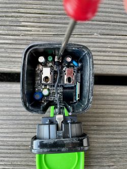 Opened plug housing with visible electronics inside.