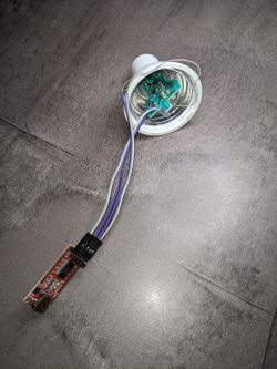 Electronic circuit board with connected wires inside a light bulb casing.