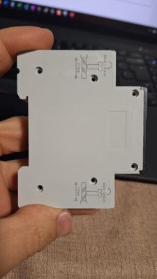 Close-up of the bottom part of a device with mounting holes and markings.