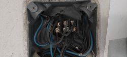 Electrical Junction Box with Power Cables Interior of an electrical box with four-core cables connected to a terminal block.