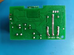 Green printed circuit board with traces and soldered points.