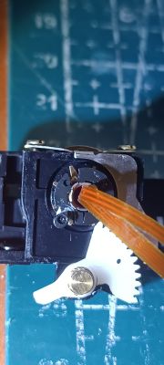 Zbliżenie mechanizmu z plastikową zębatką i śrubokrętem na macie roboczej