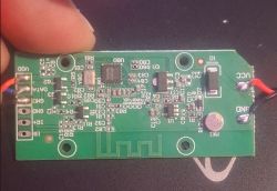 Electronic module with antenna and labeled connectors Green PCB with electronic components, labeled ports, and visible microphone