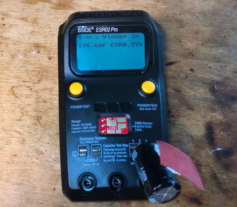 BSIDE ESR02 Pro Tester with Capacitor BSIDE ESR02 Pro tester on a wooden table with a display showing capacitor measurements.