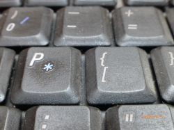 Zbliżenie na brudne klawisze klawiatury laptopa, na których widoczne są zanieczyszczenia i kurz.
