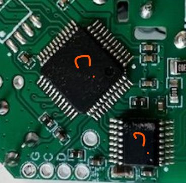 Close-up of a circuit board with two integrated circuits and SMD components