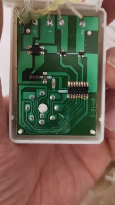 Zdjęcie wnętrza obwodu elektronicznego z widocznymi ścieżkami i elementami na płytce PCB.